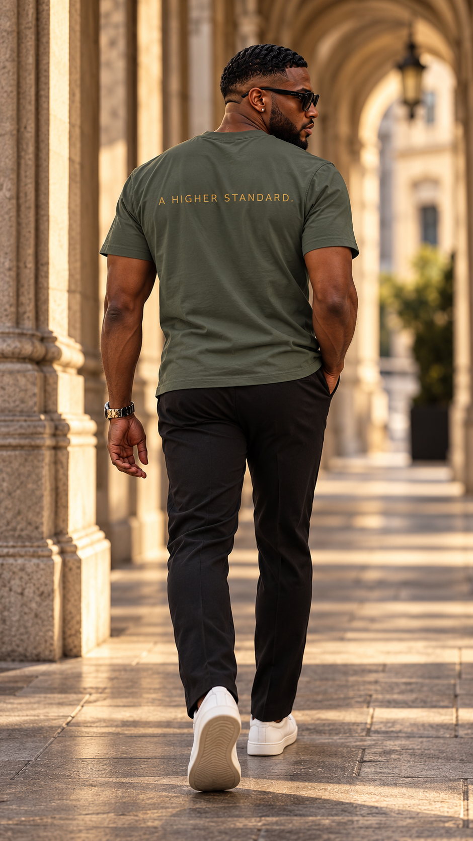 Crown SG Mono Tee, back, A HIGHER STANDARD. print, worn in a stone arcade