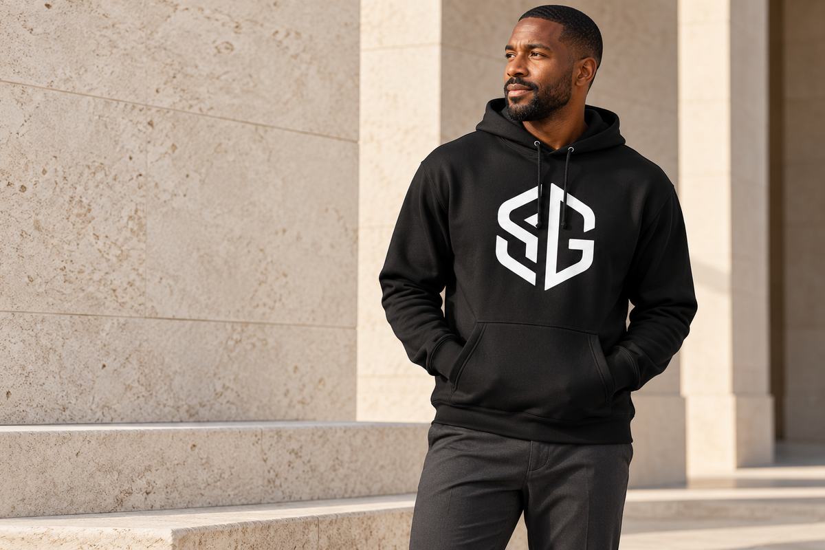 SG Signature Hoodie in black, front, worn against limestone architecture