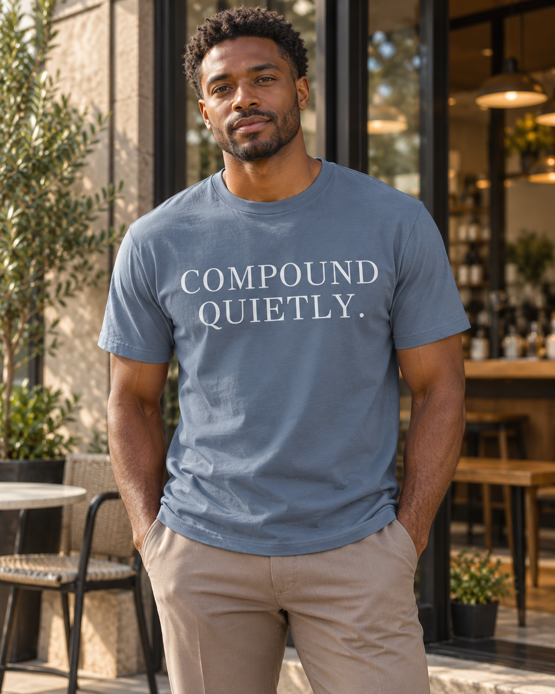 Compound Quietly™ Tee in blue jean, front, worn at a café